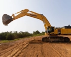 Side of new Excavator working in the field